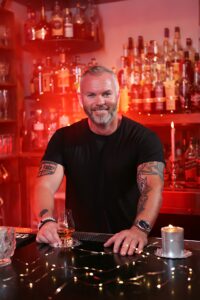 | restaurant seo, reputation management & website design | bar marketing basics erik shellenberger author headshot with a bar background